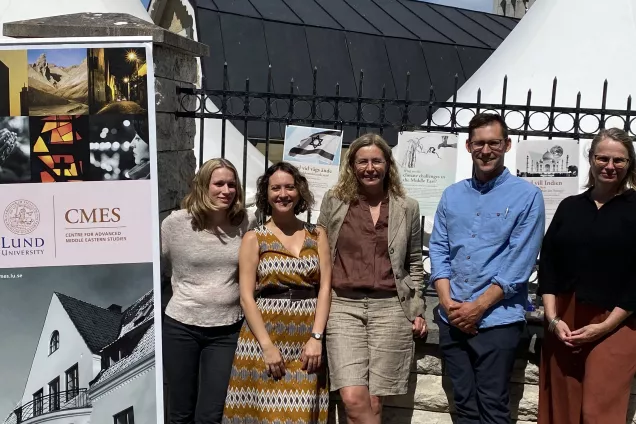 A photo of Lina Eklund, Pinar Dinc, Karin Aggestam, Stefan Döring and Sara Brogaard standing next to a CMES roll-up.